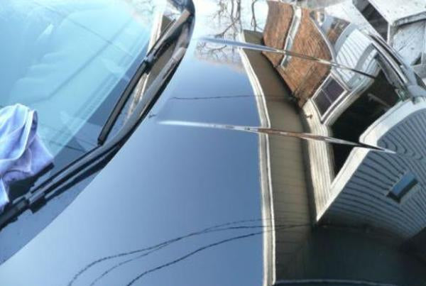 Car hood with vaporwax applied, showing a comparison to a clean car.